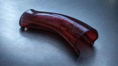 Futuristic 3D render of sleek haptic device with glowing AI interfaces